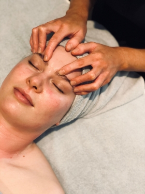 A woman receiving a facial.